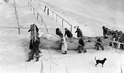 Mullet Fishermen carrying boat onto beach, Brown's Island, N.C.