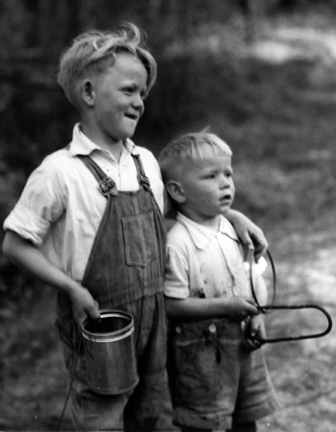 Brothers James Lewis Beasley, Jr. and Ralph Beasley at play on Little Colington Island, ca. 1938. They are playing a game the village children called “hoop and wire,” using an old coat hanger and a round gill net weight. both boys grew up and became commercial fishermen. Photo by Charles A. Farrell. Courtesy, State Archives of North Carolina