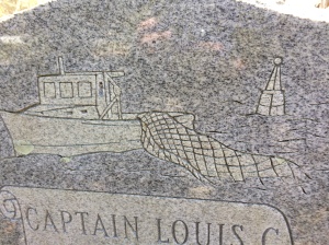 Detail from the grave marker of Capt. Louis C. Styron. Below his name and date of death, the marker reads: "Helmsman of the Sea, Beloved Pilot of our Lives"