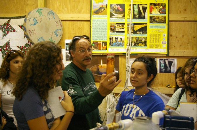 Keith Rittmaster displaying spermaceti oil to students at Bonehedge, a laboratory originally created for rearticulating a sperm whale skeleton. Courtesy, Andrew David Thaler and his fascinating Southern Fried Science blog on ocean science and conservation.