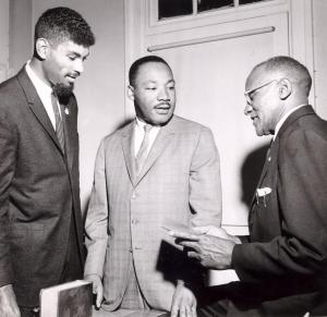 Dr. King spoke in support of a voter registration drive at Goler Metropolitan AME Zion Church in Winston-Salem, N.C., on April 13, 1964. He is standing with local civil rights leaders Kenneth Williams III and Clarence Montgomery. Courtesy, the Winston-Salem Journal