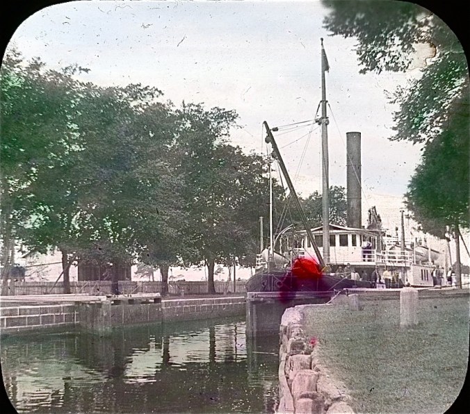 The lighthouse tender Violet at the Great Bridge Lock on the Albemarle & Chesapeake Canal, 1901. A smudge of wayward rose tint gives its forward section a bit of a beauty mark. Image by Albert Ross, USN. Courtesy, Linda Garey