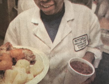 Felicia Crooms serving a plate of backbone, cabbage, boiled potatoes, hushpuppies and sweet tea at Ed Mitchell's BBQ restaurant in Wilson, N.C. Photo by Roger Winstead. Courtesy, News & Observer