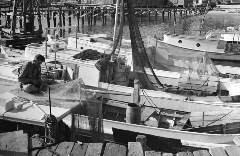 A Carteret County fisherman mending his shrimp trawl, Southport, N.C., 1938. More than 100 shrimpers from Morehead City, Atlantic, Davis Shore and other parts of Carteret County spent the fall in Southport. Courtesy, State Archives of North Carolina