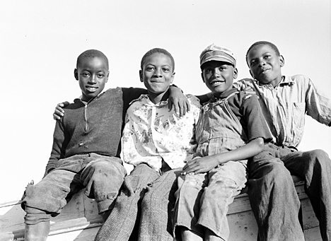 Southport, N.C., 1938. In Southport, 93-year-old ex-menhaden fisherman Charles"Pete" Joyner told me that he used to play with these boys. They'd cavort on the waterfront until the shrimp boats came in, then help unload the boats, They often helped their mothers peel and head the shrimp at the shrimp house where they worked as well. Photo by Charles A. Farrell. Courtesy, State Archives of North Carolina