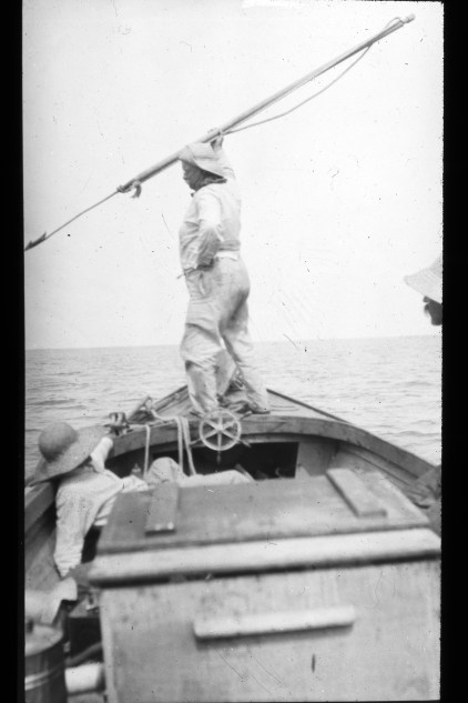 Teddy Roosevelt posing with harpoon in the bow of Capt. Jack McCann's flat-bottom skiff. Photo courtesy, Walter Coles, Sr., Chatham, Va.