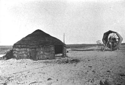 A mullet fishermen's camp, Shackleford Banks, ca. 1907. The island was Charlie Willis's home when he was a boy. For generations, thatched roof huts like this, made of salt marsh grasses and bound by yucca threads, could be found along the island's shores. Crews of fishermen lived in them during the big fall runs of striped "jumpin'" mullet. From Hugh M. Smith, The Fishes of North Carolina" (1907).