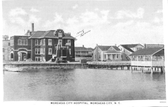 Postcard from Russell Coles of the Morehead City Hospital with "my room" marked in his hand. Whether Coles was in the hospital for a fishing injury or for his rheumatism or another ailment is not clear. He was evidently a patient sometime between 1918 and 1925. Though Dr. Benjmin Franklin Royal established the hospital in 1911, the original building only had 7 beds. The building on the postcard opened in 1918. Courtesy, Walter Coles, Sr., Coles Hill, Va.