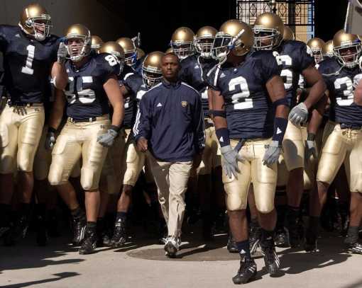 Coach Tyrone Willingham, shown here with his Notre Dame team in 2004, was a 5th grader in Jacksonville, N.C., when bombs destroyed the Georgetown High School in 1965. He often talks about the incident when he describes his youth and the adversities that he had to overcome. Photo by Sandra Dukes/Getty Images