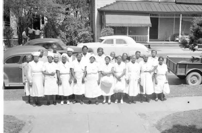 African American midwives in Greenville, 1951. According to a note in Joyner Library's files, Ms. Bessie Ward Harris (5th from left in the front row) was also a midwife and herbalist who was also well known for feeding the down and out out of her kitchen. Courtesy, Joyner Library, ECU