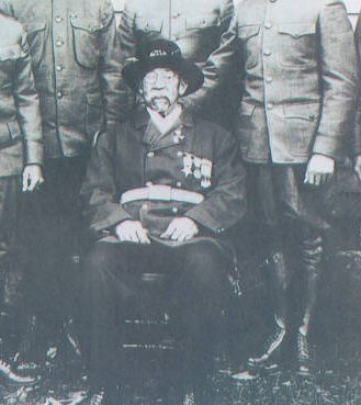 Detail of a portrait of William B. Gould I with his six sons in uniform. (Five served in WW1, one in the Spanish-American War). In 1862 Gould escaped slavery in Wilmington by confiscating a vessel and sailing to Union naval vessels. He enrolled in the Union navy and began a remarkable diary that his great-grandson, Stanford law professor William Gould IV, published in 2002. Courtesy, New Hanover Co. Public Library, NC Room. Identifier #00.171