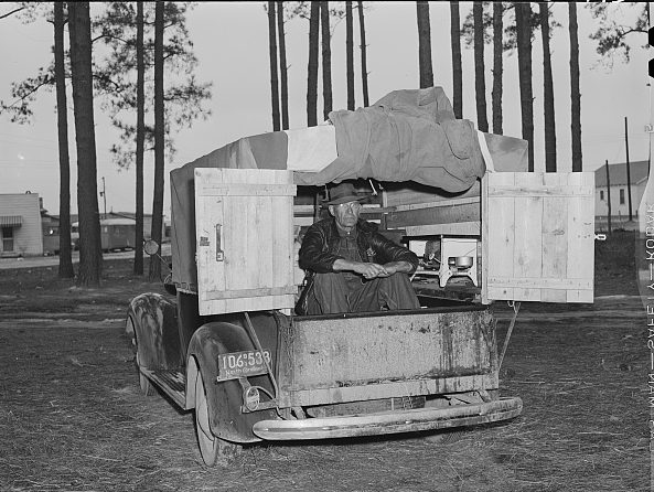 Migrant camp for Fort Bragg construction workers, near Fayetteville, N.C., March 1941. This gentleman was living in his truck while working as a carpenter at the base. He was from Hickory, N.C., 200 miles away. Courtesy, Library of Congress