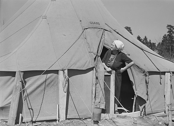 Near Fayetteville, N.C. A woman peering out a tent in a migrant camp, 1941. Photo by Jack Delano. Courtesy, Library of Congress
