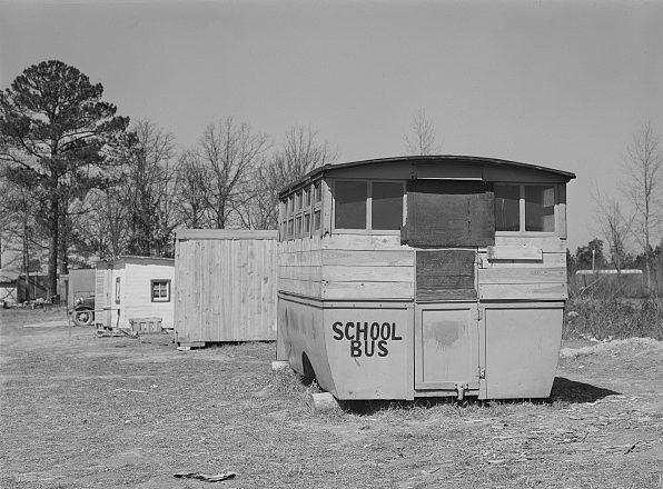 Another migrant camp near Fayetteville, N.C, 1941. The nearest shack was an abandoned school bus. Photo by Jack Delano. Courtesy, Library of Congress