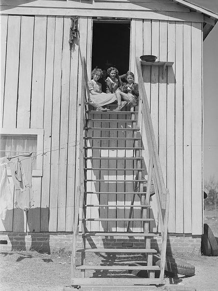 Near Fayetteville, 1941. Children sitting on the stairs of their home on the 2nd story of a tobacco barn. Photo by Jack Delano. Courtesy, Library of Congress