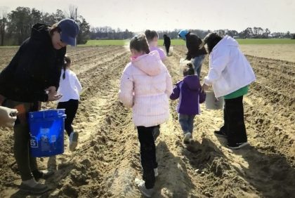 Community volunteers setting out seedlings in the Coharie Tribe's community garden. From "The Coharie Tribe: Soil, Sorghum and Sovereignty"
