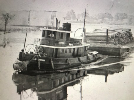 The tug Clay Foreman carrying a barge load of logs to the Foreman-Blades Lumber Mill in Elizabeth City, N.C. Courtesy, Museum of the Albemarle