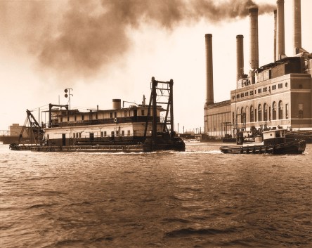 Undated photograph of a tug hauling a dredge in Norfolk Harbor. Many of the dredges that worked on the Intracoastal Waterway in N.C. were based in Norfolk. Many of the workers lived on the vessel for years at a time. Courtesy, Norfolk Dredging Co.