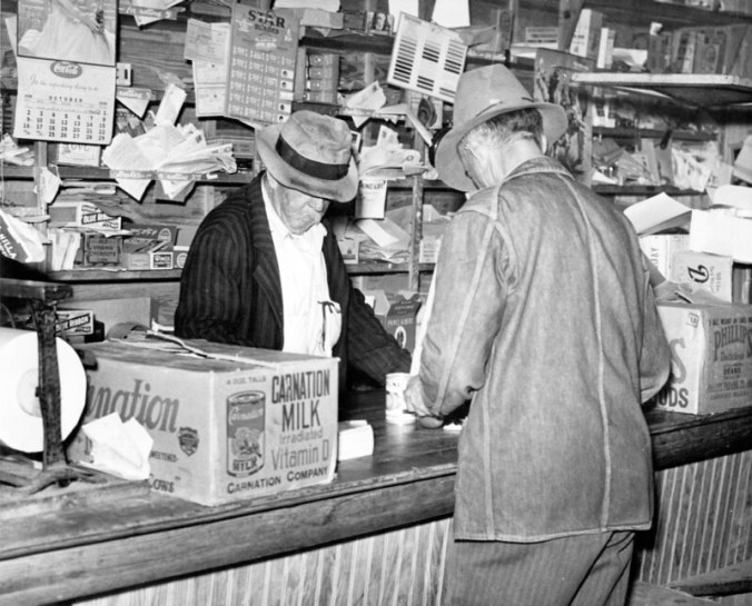 This is either Johnny Henry Fulcher (Jim's brother) at his store in Fulcher's Landing or Jim Fulcher behind the counter at his brother's store. The store was on the bottom floor of a big house next to Jim Fulcher's fish house. Many years later John Henry's daughter Edna Fisher recalled her father: "I have heard my mother tell how Papa would get up and go out 'in the midnight' to fish. He would return home early in the morning, in time to prepare breakfast for the children. (He was a widower with 5 children.).... After he grew older and no longer able to fish, he opened a store at the Landing." All 5 of the children eventually built homes within sight of it. "Every evening we would all get together at 'Papa's store' and just sit around the little stove and share the happenings of the day." John Henry lived in the back of the building. Edna Fisher recalled her father's last days especially well. "Every day after Papa ate his lunch, which usually consisted of fried fish and homemade biscuits, prepared by one of his daughters, he would lie down in the sunshine on the side porch of the house. One of the grandchildren would come and gently rub his head until he went to sleep." Photo by Charles A. Farrell. Courtesy, State Archives of North Carolina. Excerpt from The Heritage of Onslow County, N.C. (Jacksonville, N.C.: Onslow Co. Historical Society, 1983)