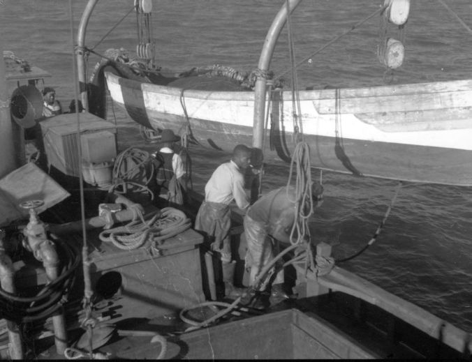 Securing a purse boat on a davit, probably on the W.A. Anderson out of Southport, N.C., ca. 1939. Photo by Charles A. Farrell. Courtesy, State Archives of North Carolina