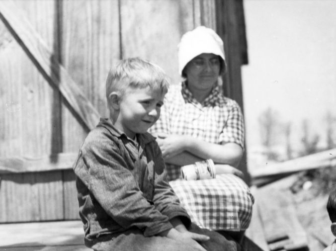 Young boy and woman, perhaps his mom, on front porch of a general store probably in Nags Head, but possibly elsewhere in Dare County, ca. 1938-39. Photo by Charles A. Farrell. Courtesy, State Archives of North Carolina