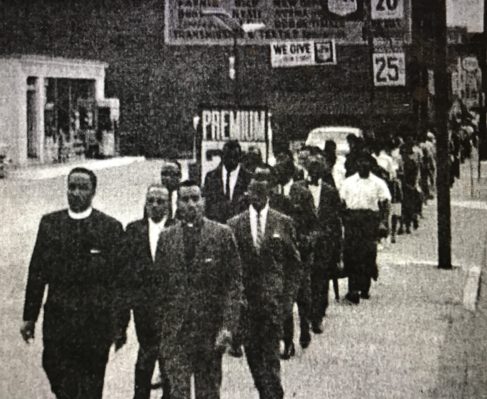 Civil rights march in New Bern, ca. 1960-63. Local civil rights activists had begun sit-ins and other civil rights protests in 1960 and they continued throughout the early 1960s. Black Marines from the Cherry Point MCAS often joined those protests. Photo from Capus M. Waynick, John C. Brooks and Elise W. Pitts, eds., North Carolina and the Negro (Raleigh: NC Mayors' Cooperating Committee, 1964).