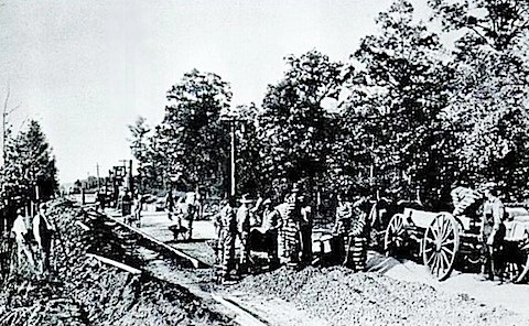 Convicts paving Reynolda Road in Forsyth County, N.C., a guard with a shotgun or sawed-off rifle standing on the left. Courtesy, North Carolina Collection, UNC-Chapel Hill