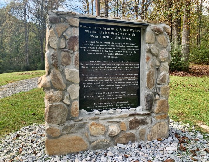 In one part of North Carolina, people have not forgotten the convict laborers who built so many of our state's railroads. In 2020, volunteers in Buncombe and McDowell counties founded a non-profit group called <a href="https://therailproject.org">The RAIL Project</a> to remember the convict laborers that were forced to build the railroad through the Swannanoa Gap in Western NC. Their efforts led to the erection of this memorial at Andrew’s Geyser in Old Fort, N.C. The group is now working to identify grave sites of convict laborers who died on the mountain and erect informational panels about them. Photo by Fred McCormick. Courtesy, <em>The Valley Echo</em>