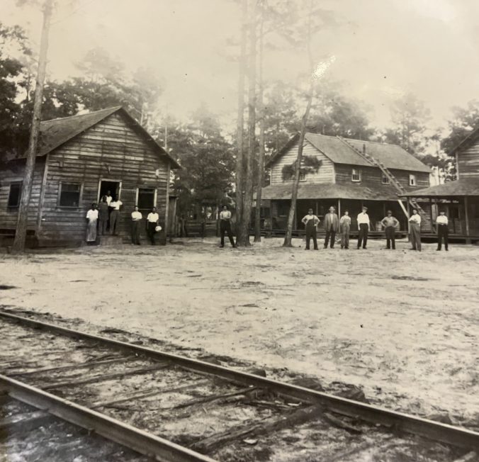 Gangs of African American mill workers lived in the "Quarters," just below the Waccamaw Lumber Co.'s mill in Bolton. One of the buildings was a boardinghouse "sorta like barracks in the army," one of the former employees told the students from Kin' Lin.' The ladder on the middle building was apparently a fixture: it served as a fire escape. Courtesy, Waccamaw Photographs & Journal, Rubenstein Library, Duke University