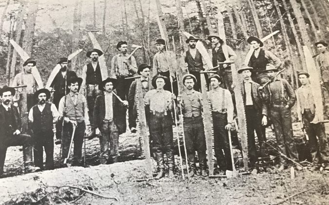 A logging crew from Pine Town on the western end of the East Dismal, May 1, 1897. Surry Parker is the man wearing a derby in the middle of the group. From Map from Elizabeth Parker Roberts, Family and Friends: Pinetown, North Carolina, 1893-1918.