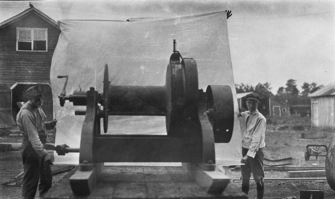 A mechanic and his helper showing off a logging winch that they had just built at Surry Parker's shops in Pinetown, ca. 1910. Courtesy, Surry Parker Photograph Collection, State Archives of North Carolina