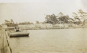 View from the pier that Co. 424 built on Rose Bay looking back to the camp's tents, ca. 1933-34. The camp's first enrollees came from seven counties in the piedmont and eastern parts of North Carolina: Brunswick, Durham, Granville, Halifax, New Hanover, Onslow, and Wilson. Within the year, a healthy contingent of the camp's young men also came from Hyde County, where Bell Island is located. Photo courtesy, State Archives of North Carolina