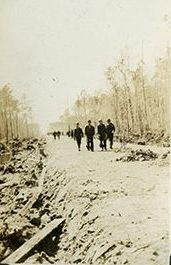 CCCers on the roadbed that they were building between Bell Island and the mainland, ca. 1933-34. At the beginning, the CCC camp at Bell Island fell under the command of a Capt. Gervais of the U.S. Army's 4th Field Artillery. That was not unusual. At first, Regular Army officers led all CCC camps. However, by the summer of 1934, or thereabouts,  they were replaced with officers from the Army Reserves.  Civilians made up most of a CCC camps' staff, however. At Bell Island, much of Co. 424's original civilian staff-- a clerk, a steward, medics, one of the work foremen, etc.-- came from Wilson County, 100 miles to the west. Photo courtesy, State Archives of North Carolina