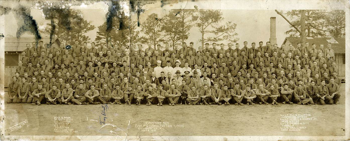 CCC Company 424 at Bell Island in Hyde County, N.C., ca. 1933-34. The first group of 200 young men to join Co. 424 participated in a two-week training session at Fort Bragg in June 1933. They then moved to Bell Island, on the shores of Rose Bay, on or about the 1st of July. From the Anthony Troy Elliott Photograph Collection, State Archives of North Carolina