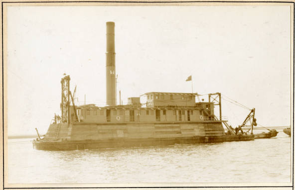 The U.S. Corps of Engineers pipe-line dredge <em>Currituck</em> crossing the bar at Beaufort Inlet, February 1931. By the time of this photograph, the <em>Currituck </em>had been working in the Army Corps of Engineers' Norfolk District for nearly 20 years. At 197-feet in length and 1,000 tons, she was a far larger boat than the other dredges featured in the photograph album that is now preserved at the Corps of Engineers' Office of History. In the 1920s and '30s, she took the lead on the building of large sections of the Intracoastal Waterway that fell in the Norfolk District's jurisdiction, including the 22-mile-long canal that runs from the Pungo River to the Alligator River. According to the edition of the Dept. of Commerce's <em><a href="http://www.ibiblio.org/hyperwar/AMH/USMM/Annual_List/1931.pdf">Merchant Vessels of the United States</a> </em>that was published in 1931, the <em>Currituck</em> typically carried six officers and a crew of 33. The striking column midship is the dredge's main spud, which is basically a heavy pipe built through the boat's hull that can be lowered and driven into the bottom of a body of water to stabilize the craft while dredging is underway. Source: Office of History, HQ, U.S. Army Corps of Engineers
