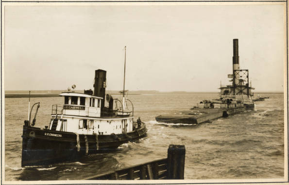 The U.S. tug Richard Caswell towing the Currituck off Beaufort, N.C., February 1931. The tug has its hands full: the two vessels are approaching the Norfolk & Southern Railroad's bridge at Gallant's Channel in a strong northeast wind and a roiling tide. The Richard Caswell was one of several tugs that towed dredge boats and barges for the Army Corps of Engineers' Norfolk District. Like all tugs, she was a tough boat: built in Southport, N.C., in 1913, she was 84.9 ft. long and had a displacement of 200 tons. Source: Office of History, HQ, U.S. Army Corps of Engineers
