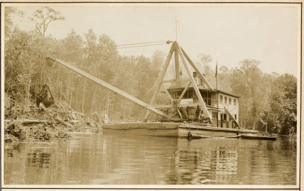 The Corps' derrick barge No. 14 on a section of the Scuppernong River near Creswell, N.C., May 1931. According to the <a href="https://books.google.com/books?id=w5WHllEy3HoC&amp;printsec=frontcover&amp;source=gbs_ge_summary_r&amp;cad=0#v=onepage&amp;q&amp;f=false"><em>U.S. Army's Report of the Chief of Engineers for 1931</em></a>, the dredge's crew spent 3 months that year removing snags from the upper part of the river and trimming and straightening the bank. The Scuppernong is a roughly 30-mile blackwater river that rises in eastern Washington County, crosses into Tyrrell County, and flows into Bull Bay, part of the Albemarle Sound.  Prior to the 1870s, the head of navigation for steamers on the Scuppernong was a site called Spruills Bridge, 23 miles from the river's mouth. Since that time, the Corps' dredges had extended navigation a little more than 2 miles, into a narrow, winding section of the river in Washington County, near the community of Cherry.  Corps dredges had also doubled the depth of the river's bar and done a good deal of channel dredging, including the excavation of a 10-foot-deep channel from the river's bar to the town of Columbia. Source: Office of History, HQ, U.S. Army Corps of Engineers