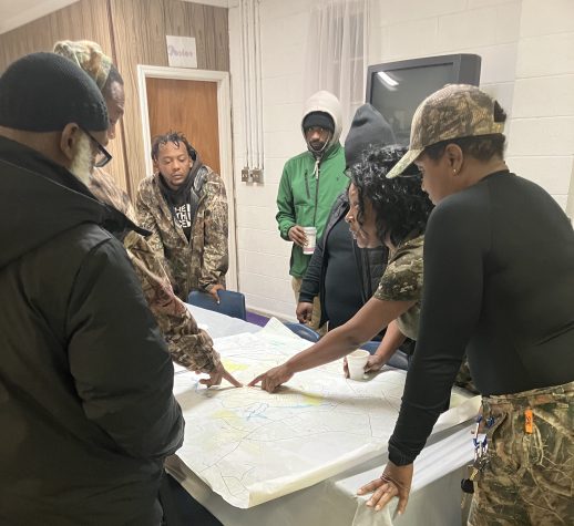 (Left to right) Vinnie Joyner, Nick Smith, BJ Herring, Antwan Evans, Melissa Evans, Marion Evans, and April O'Neal at Friendship Holiness Church. Marion started the day pointing out some of the sites that she was hoping to find on a 1913 survey map of Piney Grove.  Photo by David Cecelski