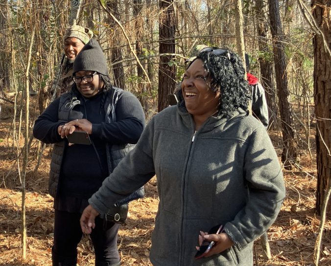 Marion Evans enjoying a very good laugh. Her sister Melissa Evans is just behind her, and Nick Smith is behind her. Photo by David Cecelski