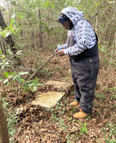Javalin Bell taking a photograph of one of gravestones. Photo by David Cecelski