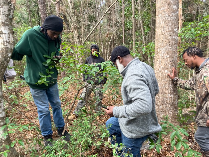 (Left to right) Wesley Newsome, Joseph Smith, Vinnie Joyner, and BJ Herring at an old cemetery just up from Pinch Gut Creek. Photo by David Cecelski