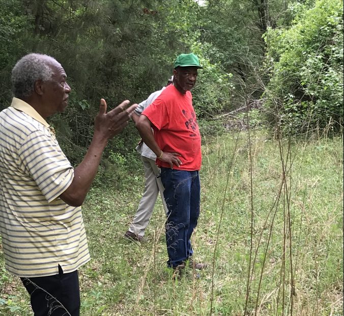 George Beatty, Jr. (left) and his brother Alfonso Beatty at the original site of Reaves Chapel, on the west bank of the Cape Fear River, 12 miles NW of Wilmington, N.C., May 2001. Using oxen and log rollers, the congregation moved the church to its current site on Cedar Hill Road in 1911. Photo by David Cecelski