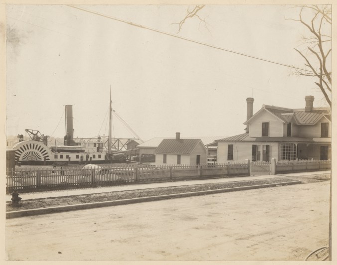 This is a rare portrait of the U.S. Lighthouse Service buoy depot in Washington, N.C., March 1914. The depot was one of 3 or 4 in the USLS's 5th District, which extended from the Delaware coast to New Inlet, on the central part of the North Carolina coast. At this site, USLS personnel stored and maintained-- painted, rebuilt, sometimes assembled-- the buoys and beacons that were used throughout much of the North Carolina coast. The depot was just below the town's bridge across the Pamlico River, where its wharf was a popular, if apparently illicit swim spot for local kids. On the righthand side of this photograph, we can see the depot keeper's house. (In 1914, the keeper was Capt. T. F. Smith, a USLS veteran who had previously been keeper of the Cape Hatteras Light for 19 years and the Ocracoke Light for 12 years.) On the left, a side wheel steamer is docked on the Pamlico. I can't be sure-- no USLS tender was ever based at the depot-- but the steamer looks a lot like the <a href="https://en.wikipedia.org/wiki/USLHT_Jessamine">USLHT <em>Jessamine</em></a>. Source: Records of the U.S. Coast Guard (RG 26), National Archives-College Park (#45694881)
