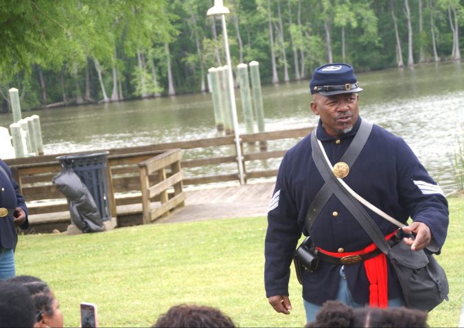 Mr. Curtis Jenkins of the 35th U.S. Reenactors Colored Troops at the commemoration of the Plymouth Massacre. Along with the 2nd Regiment, U.S. Colored Light Infantry, Battery B, the 35th set up an encampment next to the Roanoke River so that visitors could learn more about the approximately 200,000 black soldiers and sailors who served in the Civil War. Photo by Sharon C. Bryant