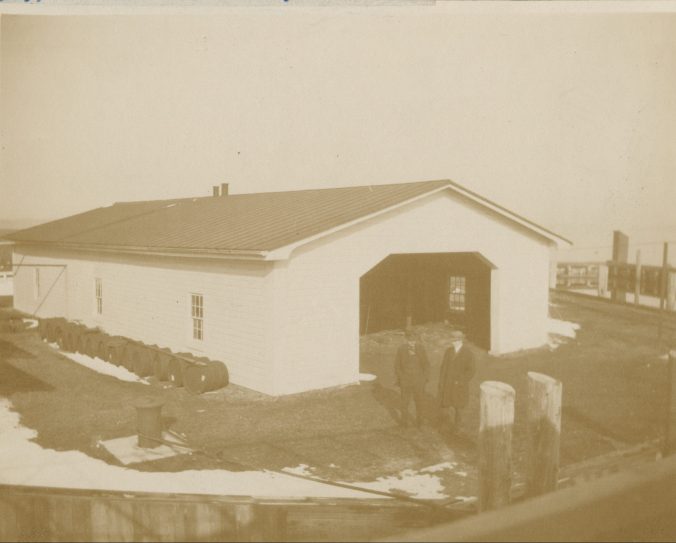 This is a view looking down from the USLS tender <em>Jessamine</em> at the gas plant that was located at the Long Point Light Station , March 1893. Established in 1879, the station ran the gas plant in order to make the compressed gas that was used to light buoys throughout that part of the North Carolina coast. At that time, the technology was still quite new. The country's first gas buoy had only been deployed 12 years earlier, in 1881-- that was at the entrance to New York Bay.  Gaslit buoys were the wave of the future however. By 1915, the USLS had more than 500 gas buoys in operation. By then, all of the USLS's lighted buoys utilized compressed gas, either oil gas or acetylene. USLS personnel deployed the gas buoys widely to mark the the entrances of rivers, inlets, and canals, as well as to signal shoals, jetties, and other dangers, as well as the paths of channels. Source: Records of the U.S. Coast Guard (RG 26), National Archives- College Park (#45694195)