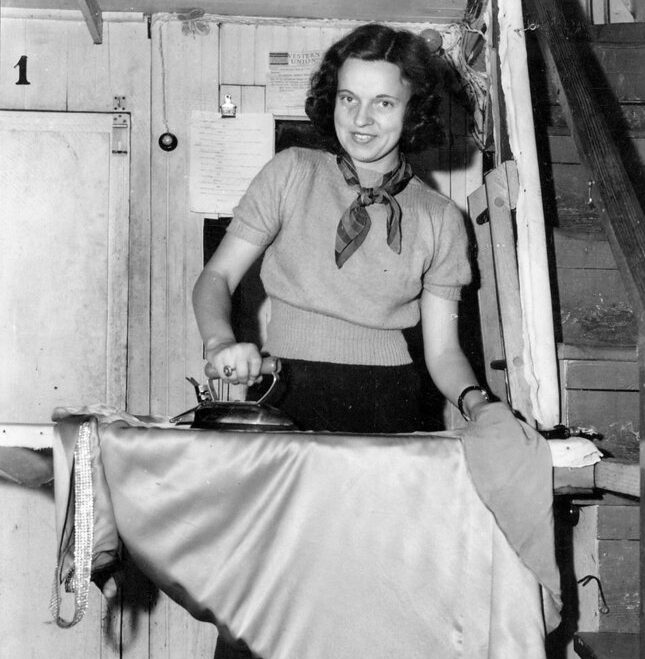 A young actress ironing one of her costumes on the James Adams Floating Theatre while the boat is tied up in Washington, N.C., 1940. Photo courtesy, State Archives of North Carolina