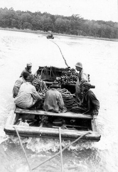 Roy Hampton's father, W. R. Hampton, was said to have run the Slade and Kitty Hawk fisheries like clockwork. During the herring and shad's runs (roughly late February to early May), the African American fishermen and women began fishing every morning at 2 AM, in the dark of night. They worked a 17-hour day, finally taking off their oil cloth jackets and boots at 7 PM, seven days a week, They fished through bitter winter storms and freezing snow and rain, their work illuminated by torches and bonfires at night. On a typical day, the fishermen made nine hauls. At the same time,  the fishery's women workers headed and gutted tens of thousands of fish a day: wet, cold, exhausting work, though often enlivened by banter and song. The fishery workers took two breaks a day for meals and a little rest. Roy Hampton's son remembered that his father "had a cook who cooked for them ... and we furnished meat and cornbread and fish ... and the guys from [Piney Woods] used to bring shallots, and they'd start a pot [of] catfish or eel or whatever in the hell they could get." Photo courtesy, State Archives of North Carolina