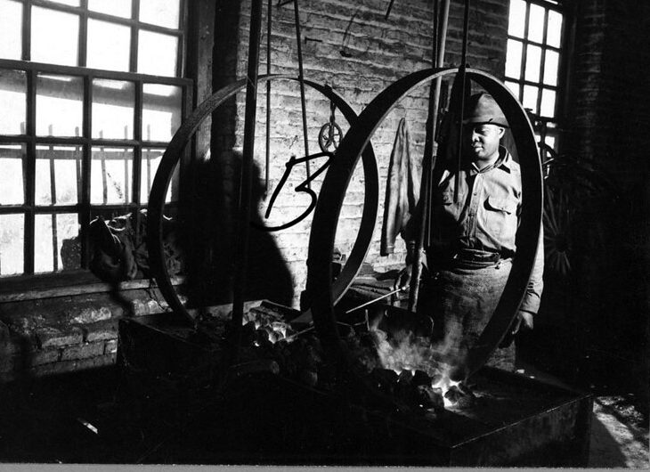 One of the company's blacksmiths at work. Courtesy, State Archives of North Carolina
