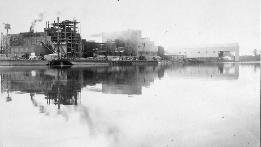 The North Carolina Pulp Company's mill, Roanoke River, Nov. 1945. The company was a division of the Kieckhefer Container Company, a pioneering maker of shipping containers, paperboard (cardboard, fiberboard, etc.), and milk cartons. The use of pulp wood in the manufacture of corrugated and fibre boxes for use as food containers (such as milk cartons) was not sanctioned in the U. S. until early in the 20th century. However, the business boomed in the 1920s and '30s. Eyeing the coming of World War II, the company's leaders, J. W. and Herbert Kieckefer, feared that they would soon no longer be able to important pulp wood from Scandinavia, their main supplier at the time. That concern led them to open the mill in Plymouth in 1937. The plant was vast: by 1940, the mill employed some 500 workers and the company employed another 800 loggers in its extensive forest holdings. The company's woodyard sometimes held logs from as many as a quarter million trees at a time.  (For more on the history of the Kieckhefer Container Company, see the <a href="https://foresthistory.org">Forest History Society's</a> on-line exhibit <a href="https://foresthistory.org/digital-collections/kieckhefer-container-company/">here</a>.) Photo courtesy, State Archives of North Carolina