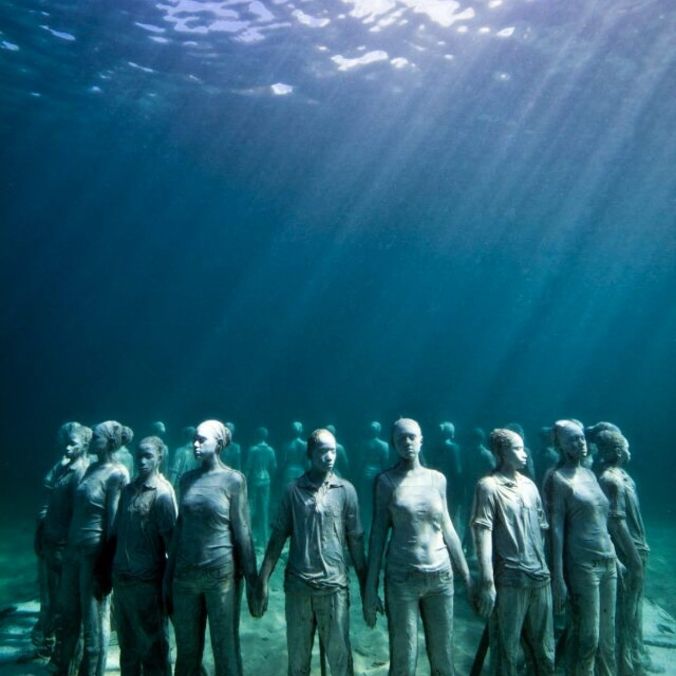 Located in waters off the Grenada coast, Jason deCaires Taylor's underwater sculpture “Vicissitudes” depicts 25 young people holding hands and is often interpreted as a memorial to those who died in the Transatlantic Slave Trade. 